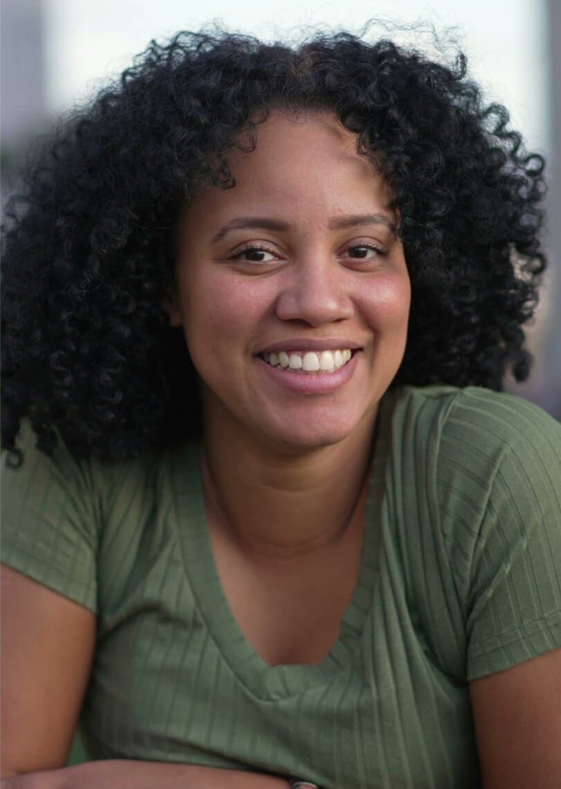 Alejandra, a woman with black curly hair